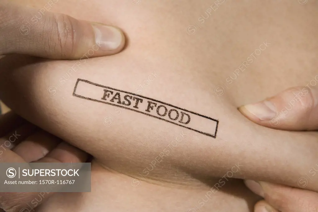 A man pinching part of his abdomen stamped 'Fast Food'