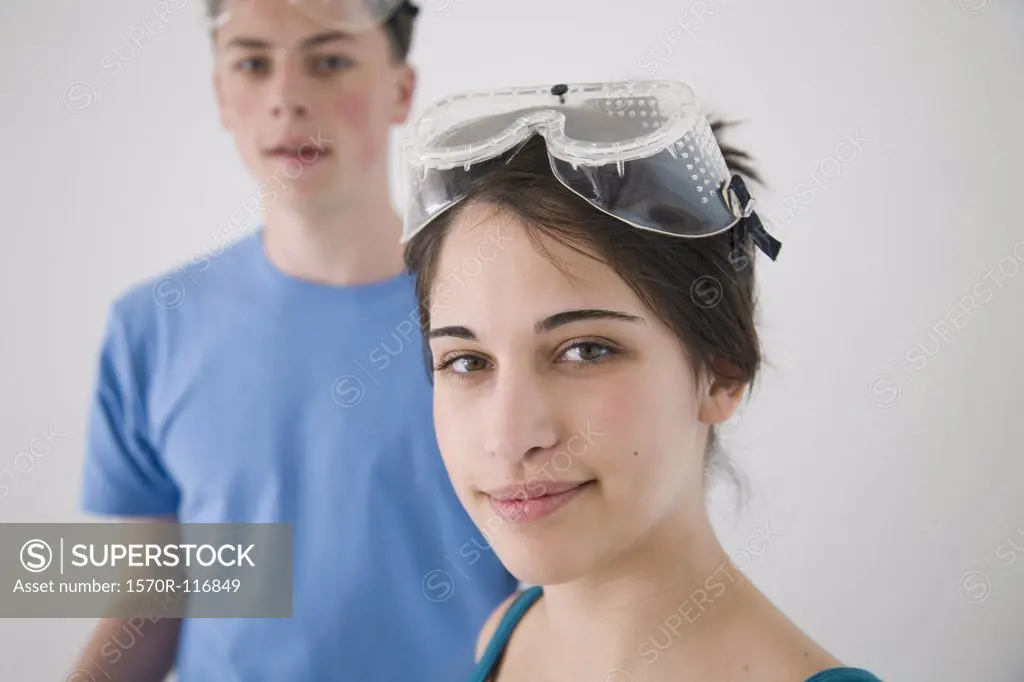 Two teenagers wearing safety glasses