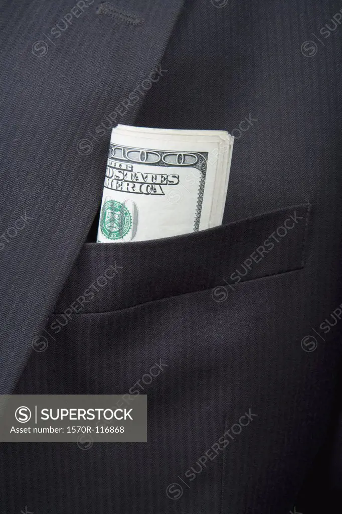 Detail of folded US bank notes in a suit pocket