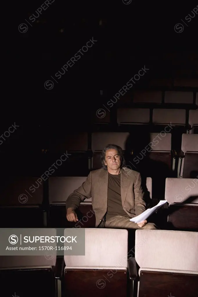 A director sitting in a theater