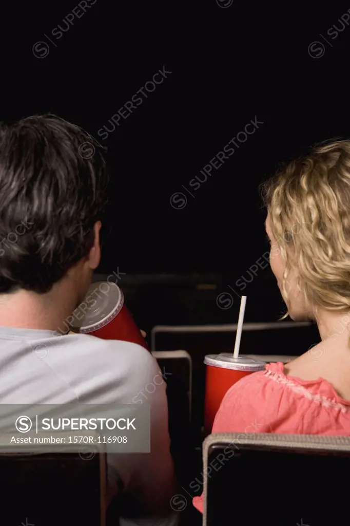 Rear view of a mid adult couple sitting together in a movie theater