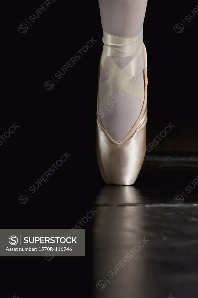 A ballerina balancing on tiptoe