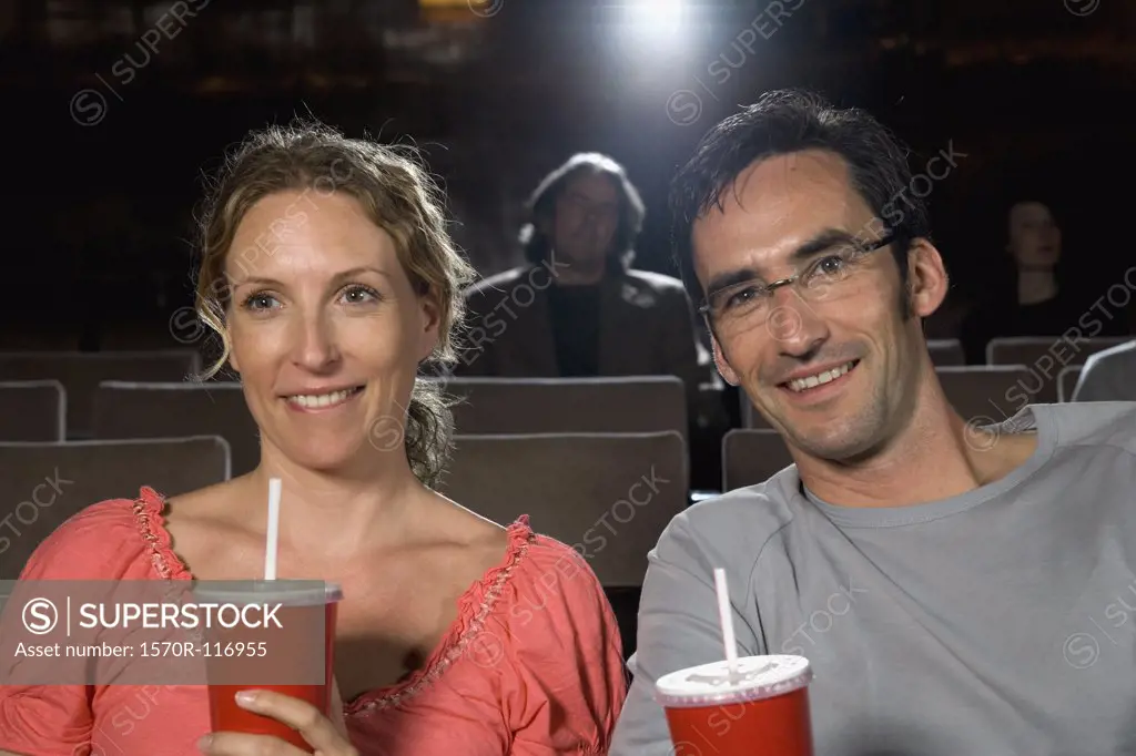 A mid adult couple sitting together in a movie theater