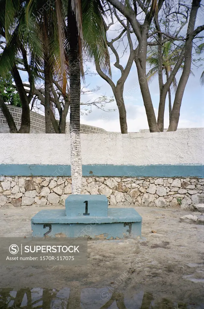 An old winners podium at a abandoned swimming pool complex