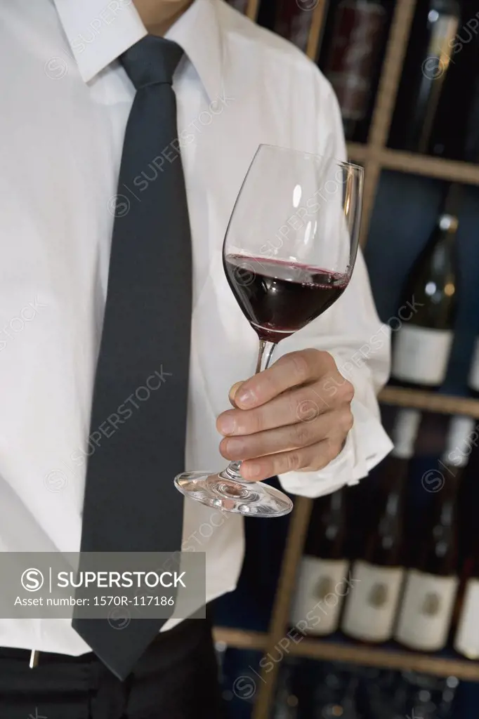 A man holding a glass of wine
