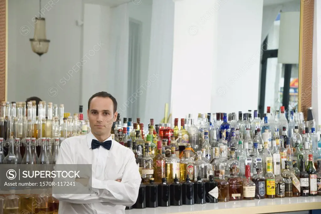 A bar tender standing at the bar