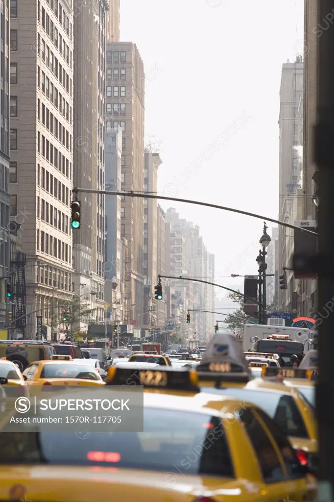 Taxis driving down a street in Manhattan