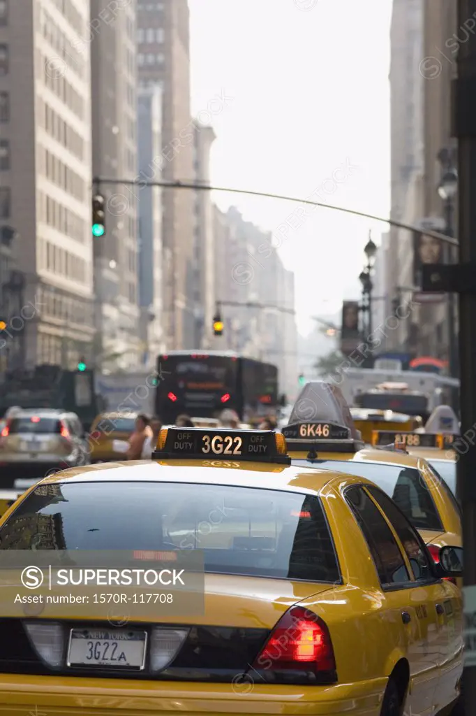 Taxis driving down a street in Manhattan