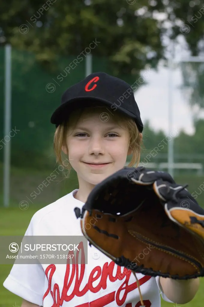 Portrait of a young girl with a baseball glove
