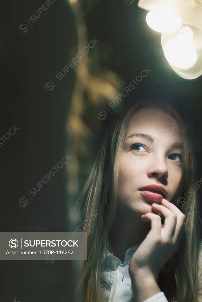Young woman reflected in mirror looking away