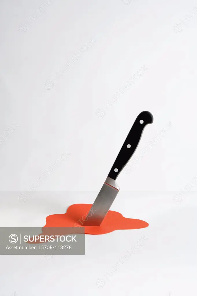 A knife stuck in paper blood