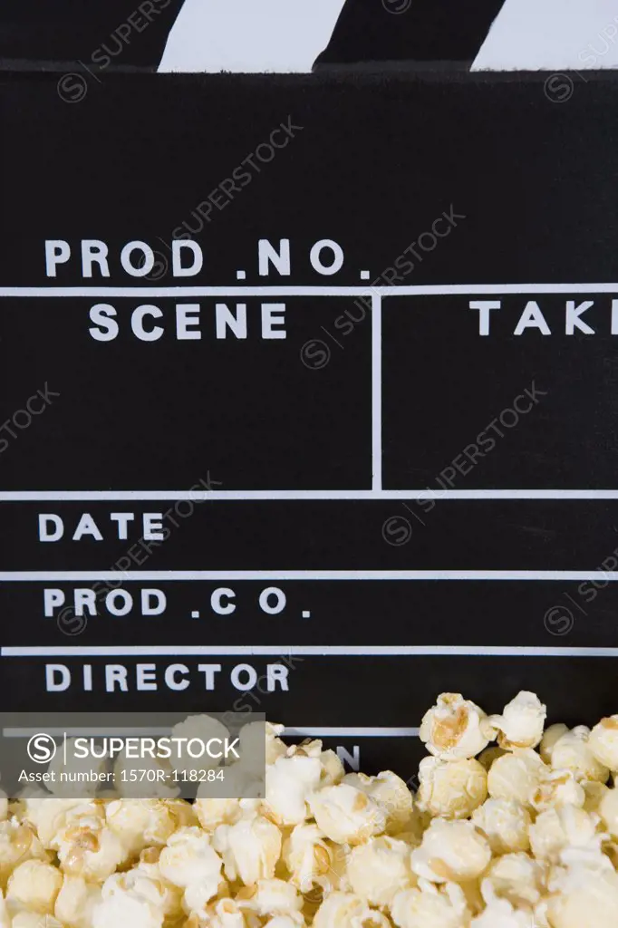 Detail of popcorn and a movie clapperboard