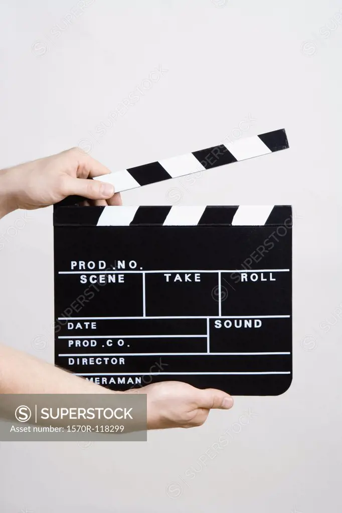 A man holding a movie clapperboard