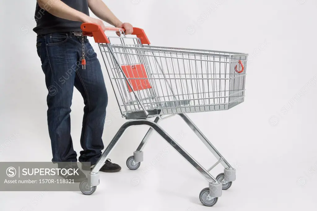 A man pushing a shopping trolley