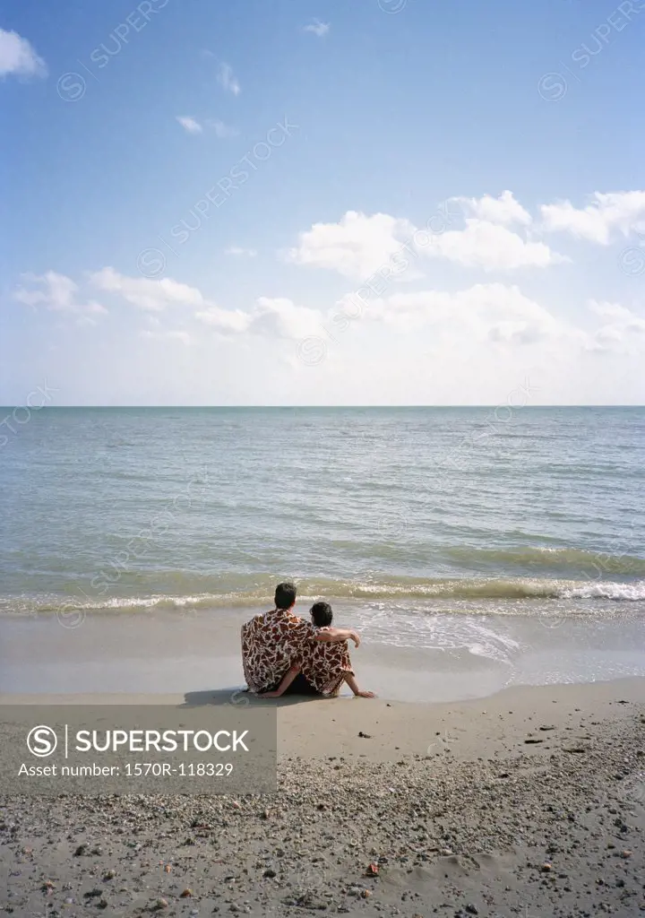 A couple sitting on the beach together