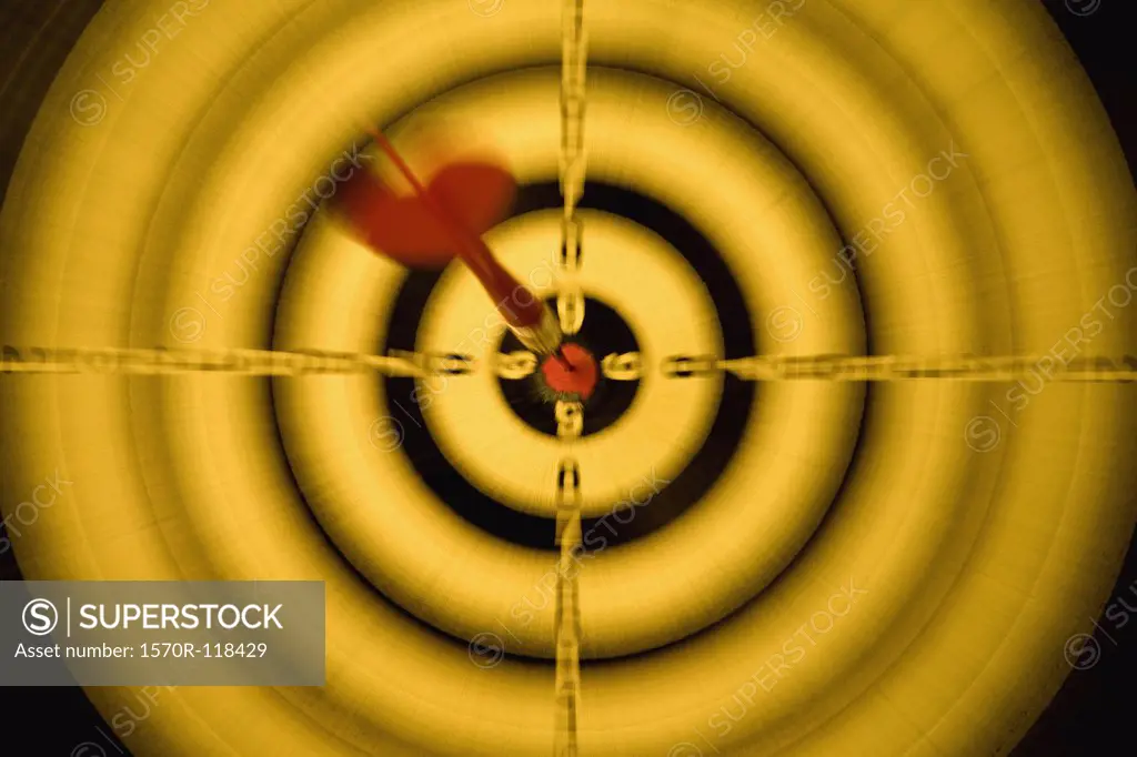 A dart in the bull's eye of a dartboard