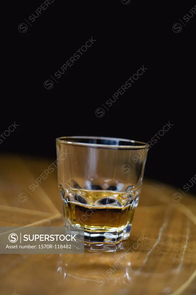 A glass of whiskey on a table