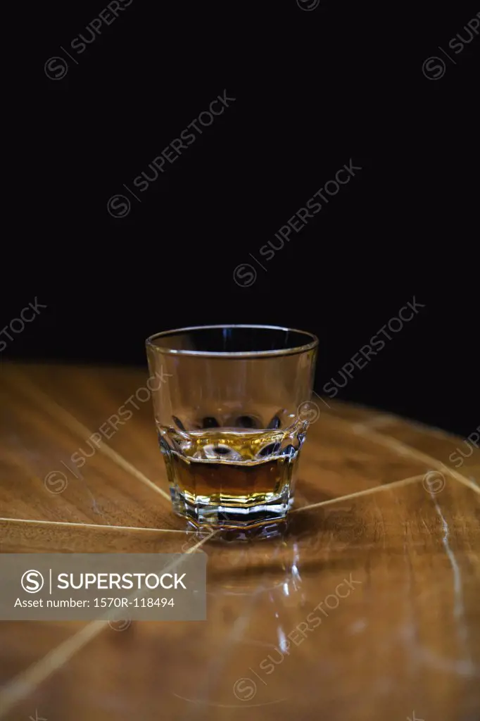 A glass of whiskey on a table