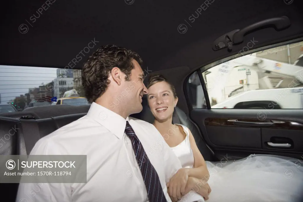 A bride and groom in a car