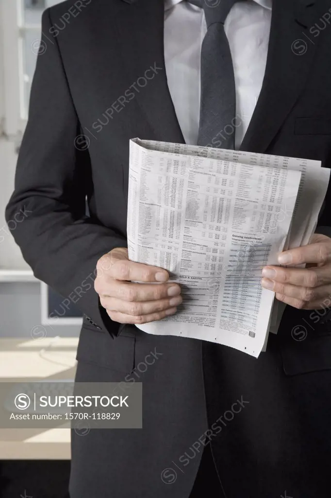 A businessman holding a newspaper