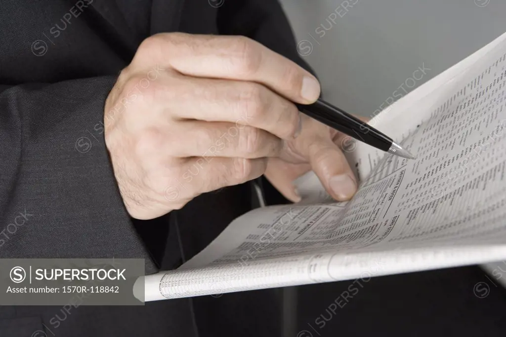 A businessman holding a newspaper