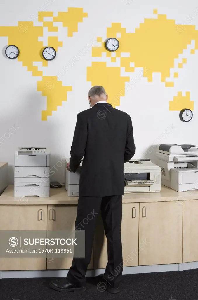 A man using a photocopier at work