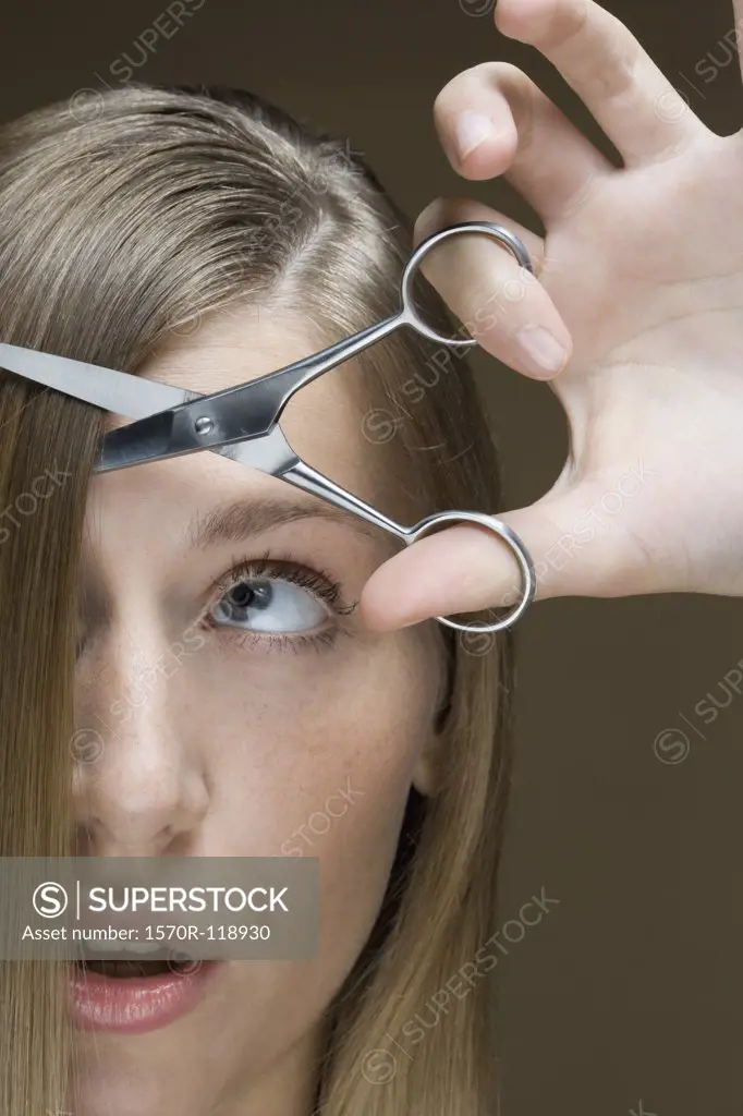 A woman cutting her hair