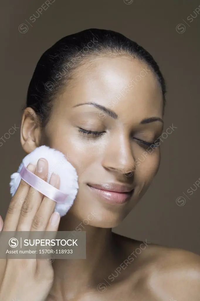 A woman using a powder puff