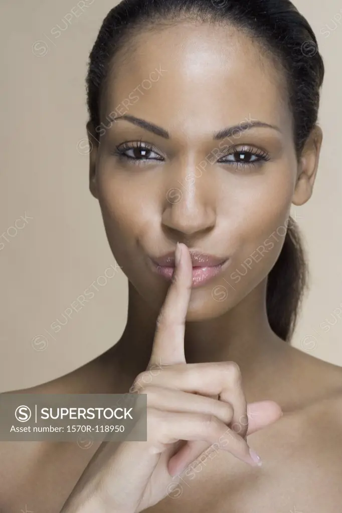A woman putting her finger on her lips