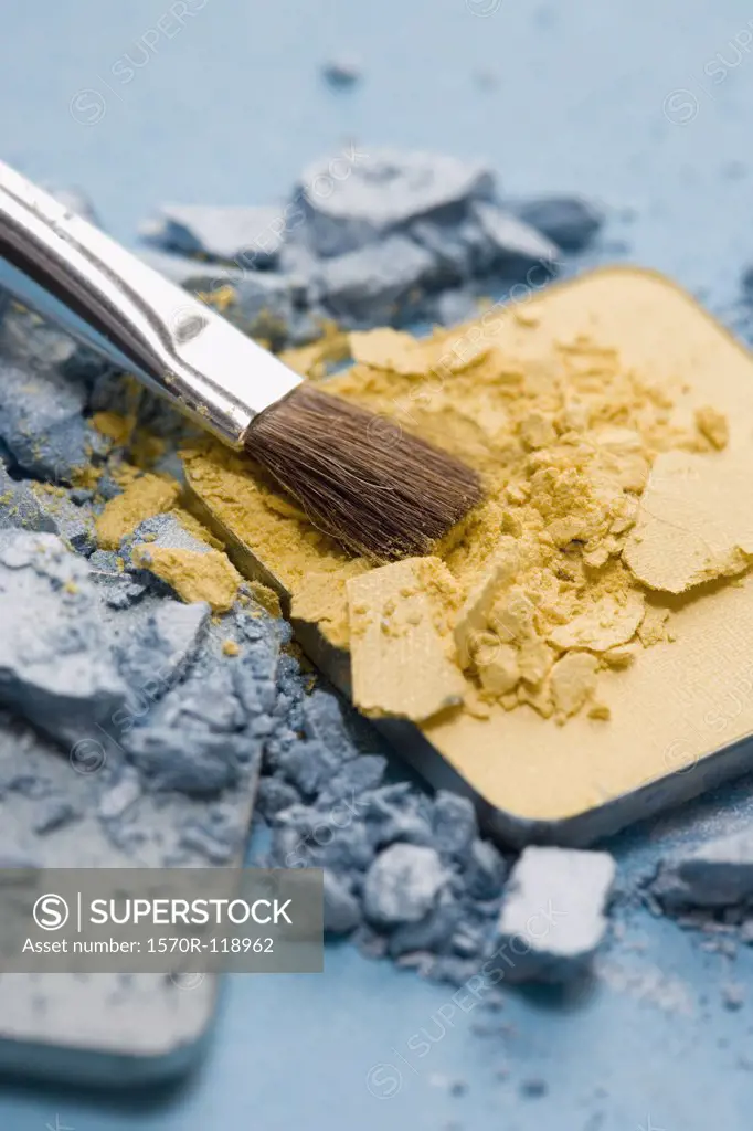 A make-up brush with blue and yellow eyeshadow