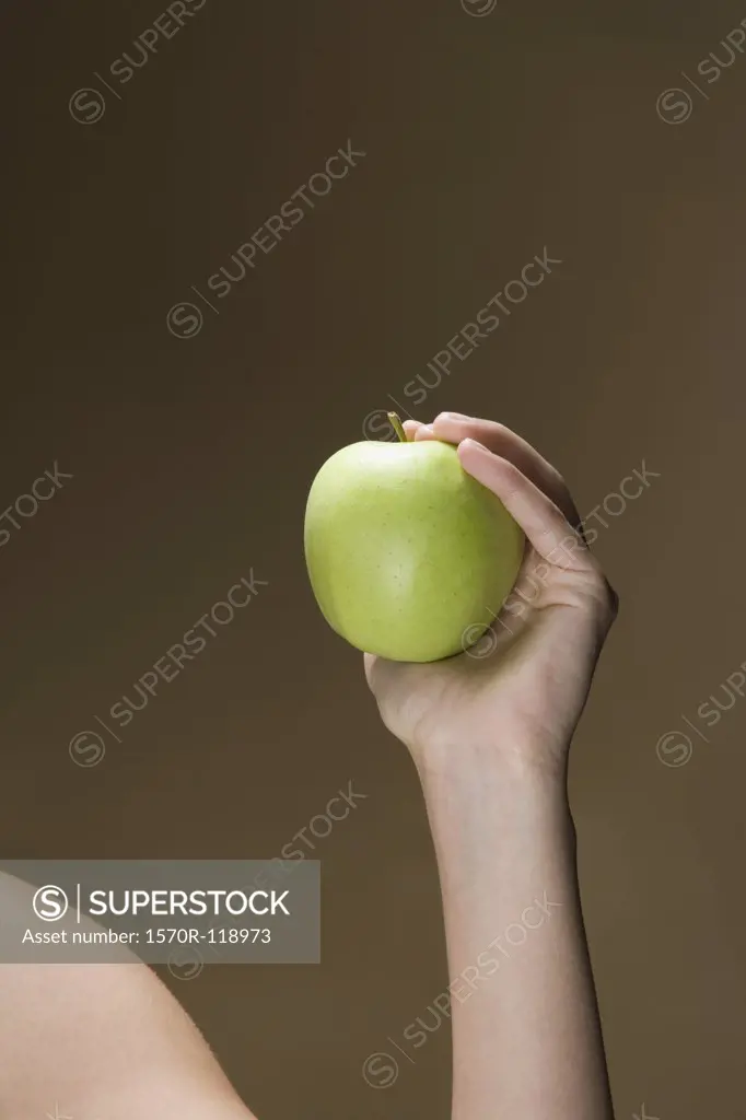 A hand holding an apple