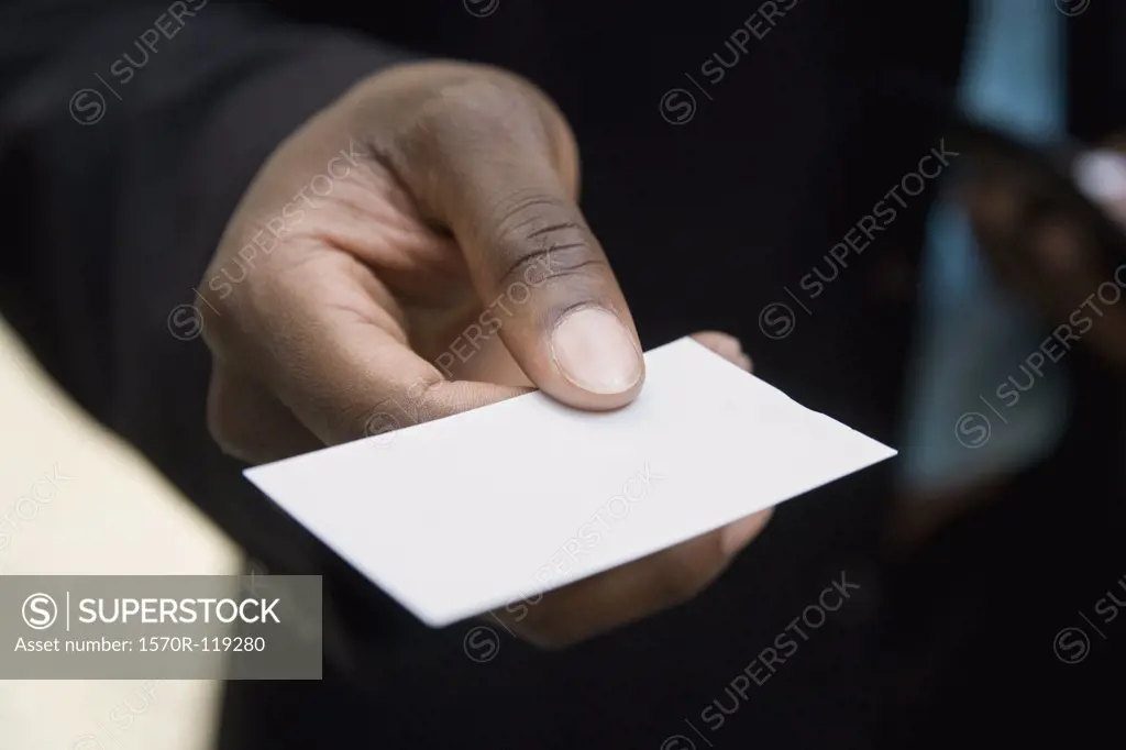Hand holding out a blank business card
