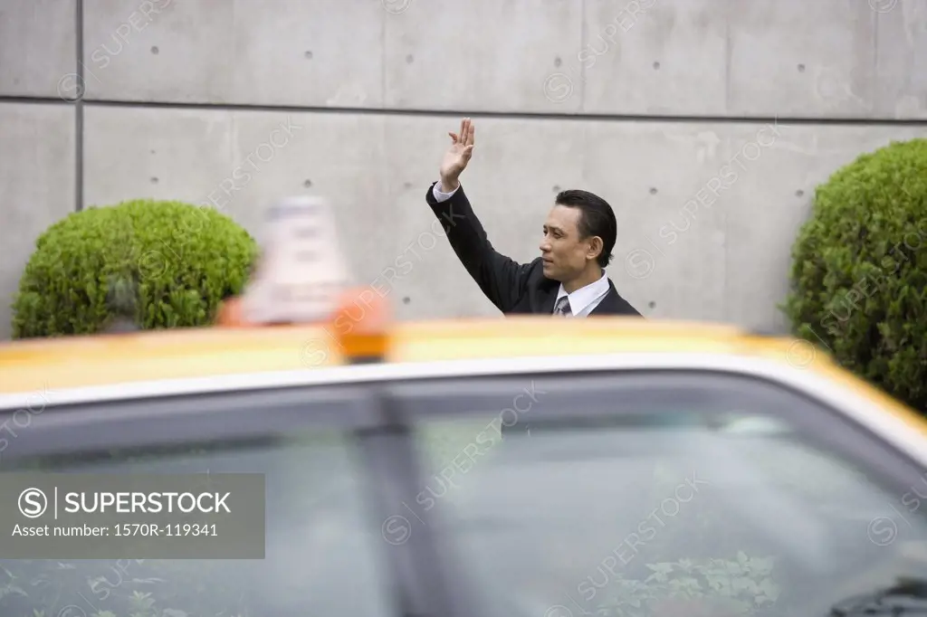 A businessman hailing a taxi