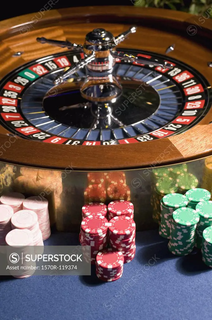 Roulette wheel with stacks of gambling chips