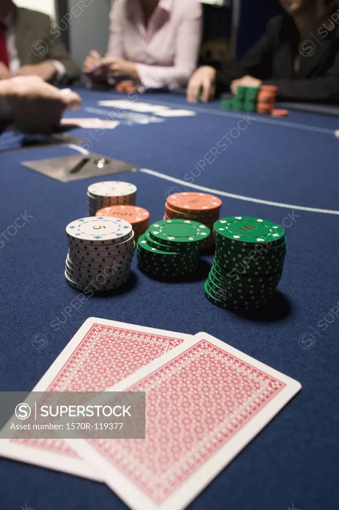 Playing cards and stacks of gambling chips on casino table