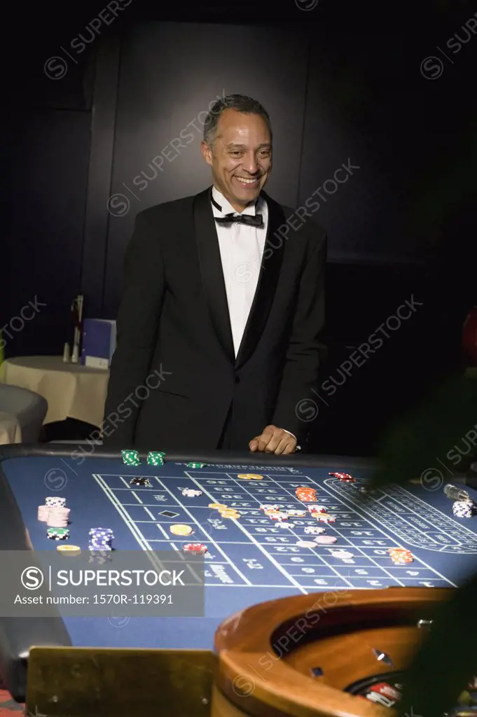 Well dressed man gambling at the roulette table