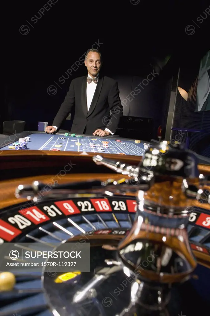 Well dressed man playing roulette in casino