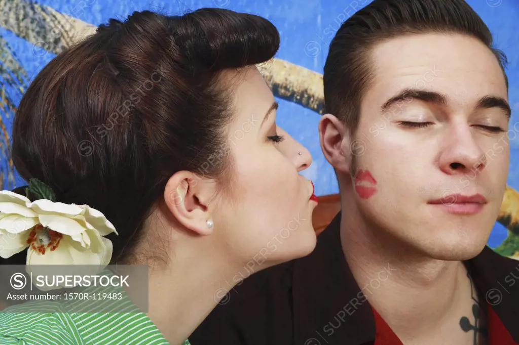 Woman giving her boyfriend a lipstick kiss 