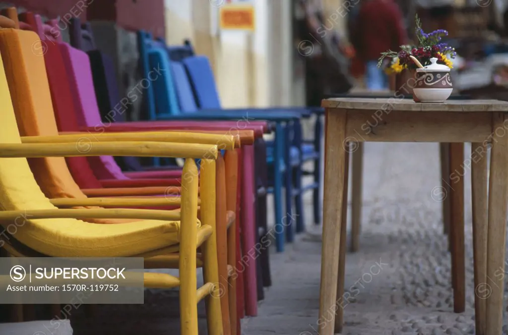 Colorful chairs and wooden tables at an outdoor cafe, Peru