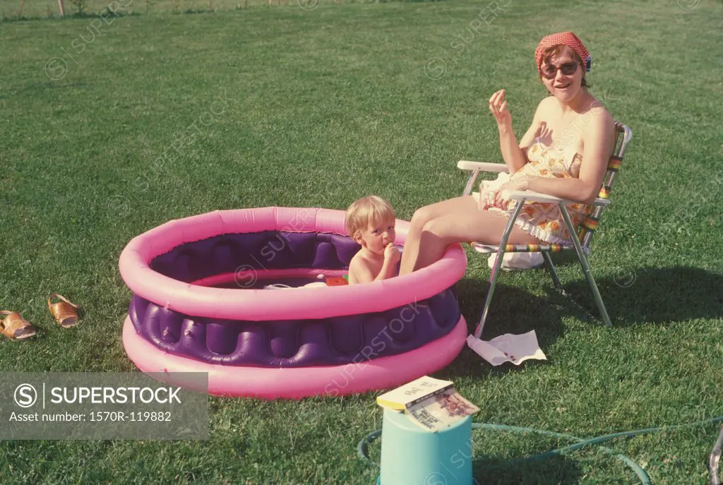 Mother and son together in a wading pool