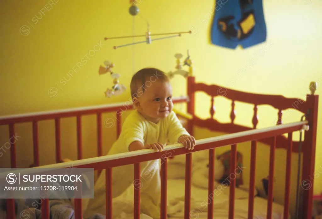 Baby boy standing up in his crib