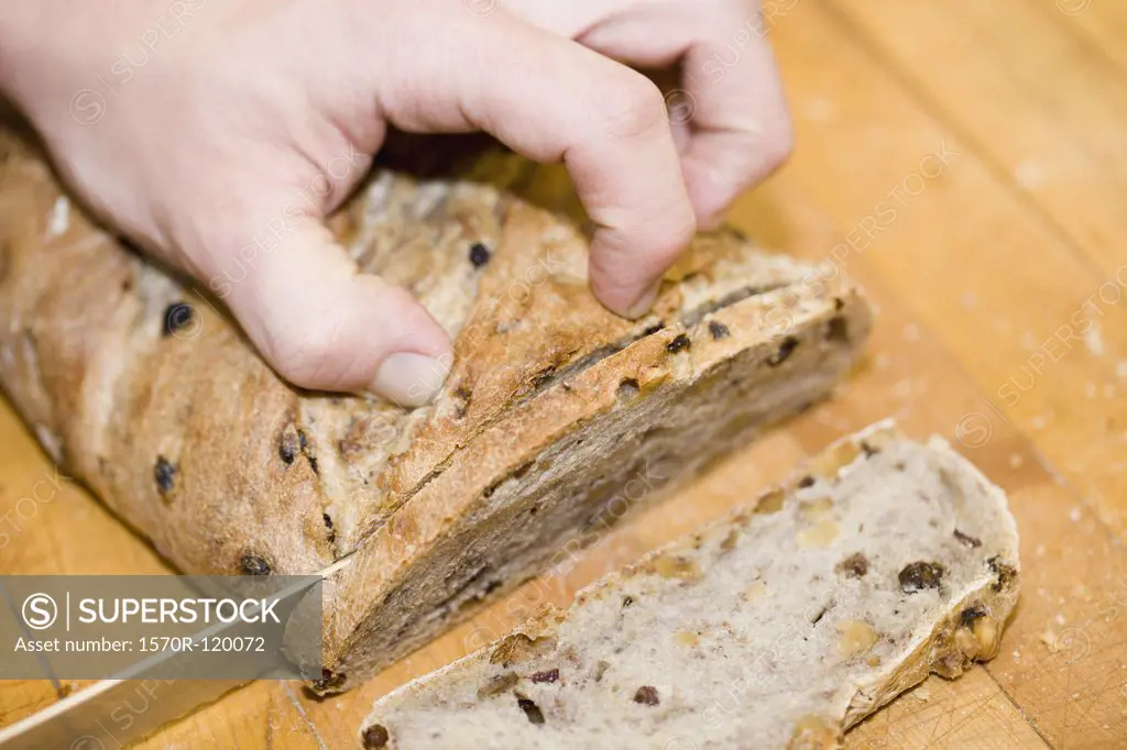 Person slicing stollen on a cutting board