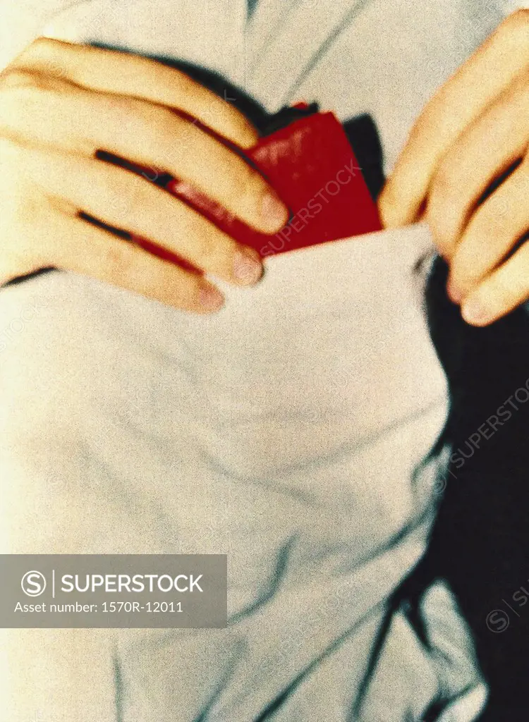 man putting wallet into pocket