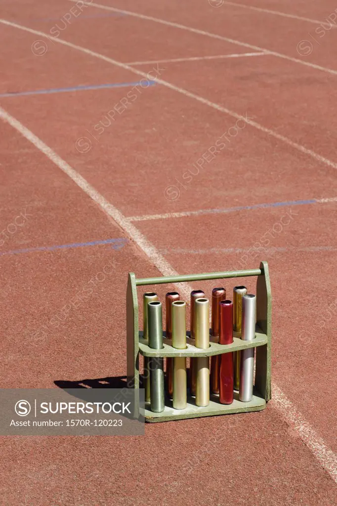 Crate of relay batons on a running track