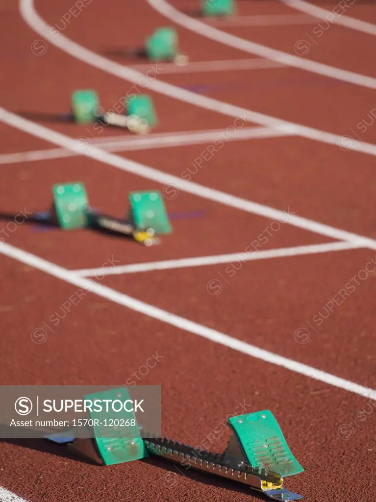 Starting blocks positioned on a running track