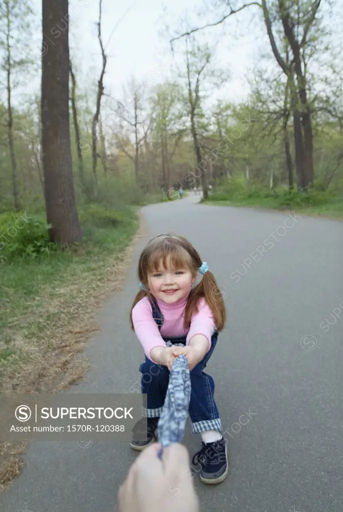 Young girl pulling on cloth