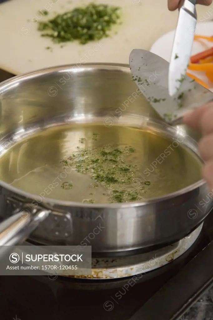 Oil and parsley in a frying pan
