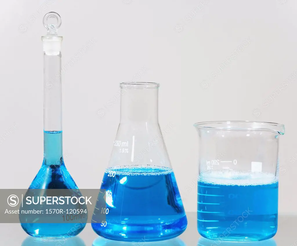 Blue solution in assorted laboratory glassware