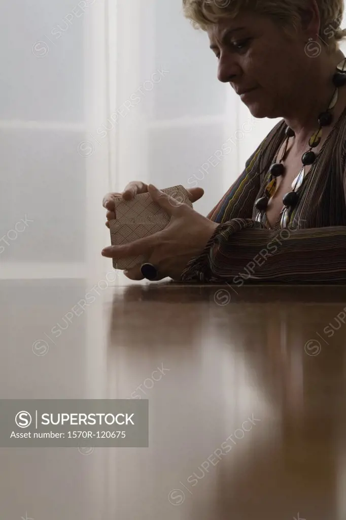 A woman shuffling tarot cards