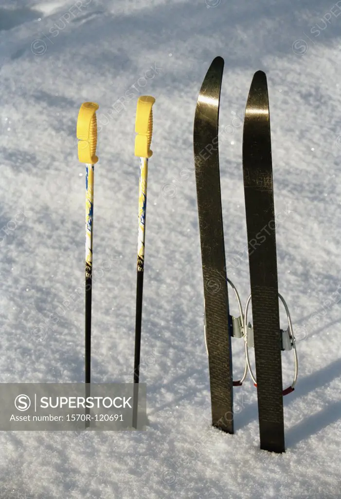 Skis and ski poles in the snow